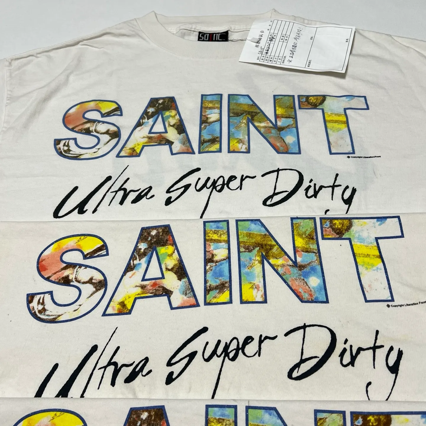 SAINT Mxxxxxx SS TEE/SUPER DIRTY/WHT oil painting SAINT SUPER DIRTY slogan TEE off-white S-XL Made of original OE yarn tube weaving without side seams to distinguish the split fabrics original consistent VINTAGE label/little angel anti-counterfeiting label top printing technology highly restored original details